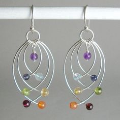 the earrings are made with silver wire and multicolored glass beaded beads on them