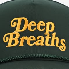 Mental health has always been at the heart of TAFT. Our new Deep Breaths Hat in Pine serves as a kind reminder to take a pause, exhale, and take care of yourself. Features an embroidered "Deep Breaths" message in gold, complete with an embroidered black heart side patch. Details: 5 panel structured cap Adjustable snapback Braided rope detail Made with a cotton/polyester blend front and polyester mesh back One size fits most 10% of proceeds will be donated to Made of Millions and Mental Health Am Gym Hats, Caps Game, Mad Hat, Silly Shirt, Patch Hats, Deep Breaths, Balanced Life, Kind Reminder, Shirt Print Design