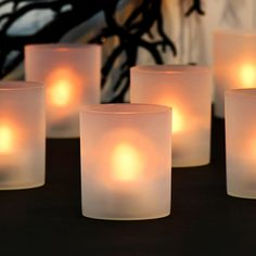 several lit candles sitting on top of a table