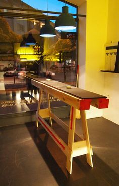 a wooden table sitting in front of a window