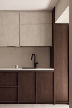 a kitchen with wooden cabinets and white counter tops, along with a black faucet