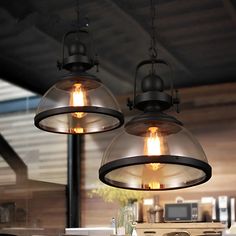 two lights hanging from the ceiling in a kitchen