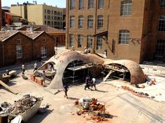 people are working on the roof of an old building