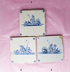 three blue and white tiles with images of people on boats in the water, sitting on a pink cloth