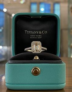 an engagement ring in a box on a table