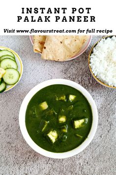 a white bowl filled with green soup next to bowls of rice and cucumbers