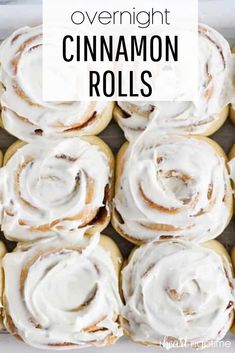 cinnamon rolls with icing in a white box