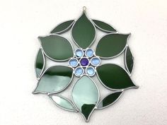 Beautiful Vintage Collectible Stained Glass Blue Green Flower Design Window Suncatcher Art Home Decor .  Condition : pre-owned - shows use . Actual size is : 7 3/4" wide ( widest part ) . Item is well packed , you will get a good shipping !!! Look at the pictures for description . Any question you have , please ask . DON'T FORGET TO CHECK OUT MY OTHER ITEMS ! ! ! & SAVE ME AS A FAVORITE SELLER ! ! ! Thank you !! Simple Stained Glass Ornaments, Flower Stained Glass Patterns, Stained Glass Art Window, Glass Art Window, Stained Glass Blue, Stained Glass Sun Catchers, Flower Stained Glass, Glass Sun Catchers, Window Suncatchers