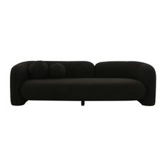 a black couch sitting on top of a white floor