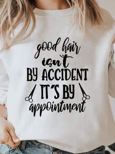 a woman wearing a sweatshirt that says good hair isn't by accident it's by appointment