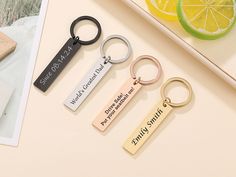 three keychains with two different sayings on them, one has a lemon and the other is a piece of wood