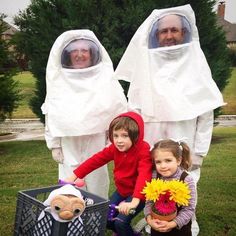 two children and an adult in white suits