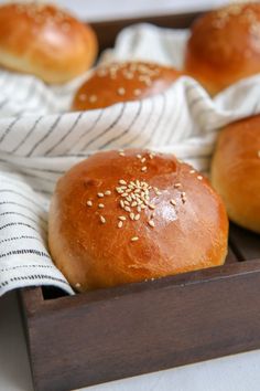 bread rolls with sesame seeds in a wooden box