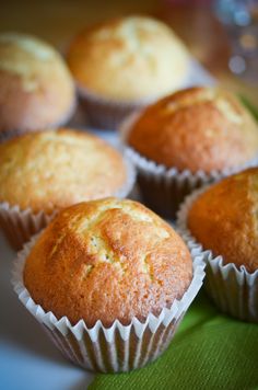 several muffins sitting on top of a green cloth