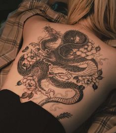 a woman with a dragon tattoo on her back