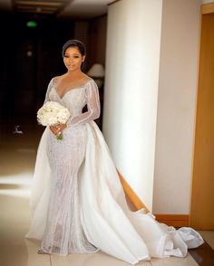 a woman in a wedding dress holding a bouquet