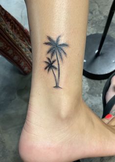 a small palm tree tattoo on the ankle