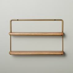 two wooden shelves are hanging on the wall