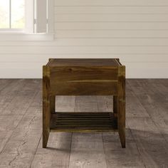 a small wooden table sitting on top of a hard wood floor next to a window