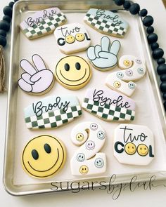 decorated cookies on a tray with words and smiley faces