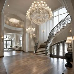 a large foyer with chandelier and stairs leading up to the second floor area