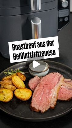 a black plate topped with meat and potatoes next to an instant pot roaster oven