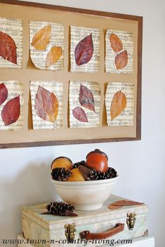 a bowl of fruit sitting on top of a dresser