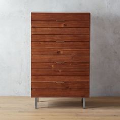 a wooden chest of drawers sitting on top of a hard wood floor next to a wall