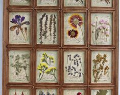 an old wooden frame with many different flowers on it's front and back sides