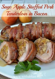 an image of stuffed pork tender in bacon on a plate with oranges and parsley