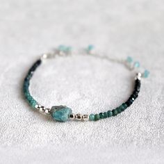 "Raw Apatite and Shaded Blue Tourmaline Bracelet. October birthstone gift. Skinny, Boho Style Multi Gemstone Bracelet.  Created using beautiful, micro faceted  shaded Tourmaline beads, paired with stunning, aqua blue, raw Apatite stone and a bright, shiny sterling silver or 14k gold filled spacer beads. These natural AA grade  Tourmaline beads are gorgeous - beautiful ombre shades of pale and dark, almost black blue which are emphasised by their tiny facets.  This multi gemstone bracelet is adjustable in size, between 5.5\" - 8\".  The 2.5\" extension chain is decorated with few dangling, faceted, aqua blue apatite gemstone beads. This natural gemstone bracelet looks amazing on its own or layered with other bracelets. A beautiful addition to your individual, bohemian style. Natural gemston Apatite Bracelet, Chinese Bracelet, Apatite Jewelry, Black Tourmaline Bracelet, Boho Style Bracelets, Multi Gemstone Bracelet, Apatite Stone, Tourmaline Bracelet, Silver Bead Bracelet