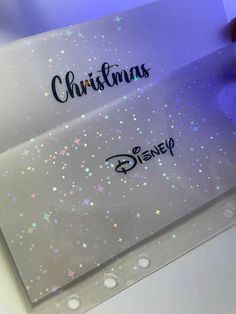 the disney christmas card is being held by someone