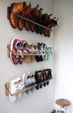 several pairs of shoes are hanging on the wall