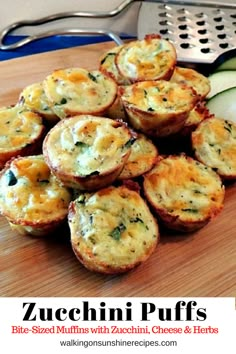 zucchini puffs with cheese and herbs on a cutting board next to cucumbers