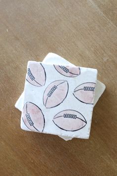 a piece of paper with footballs on it sitting on top of a wooden table