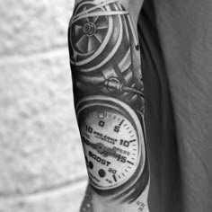 a black and white photo of a man's arm with a clock on it