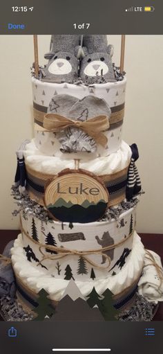 a triple layer diaper cake sitting on top of a table next to a cell phone