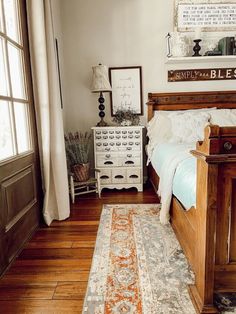 a bed room with a neatly made bed and a rug