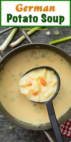 a ladle filled with soup on top of a table next to utensils