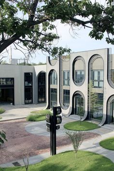 a building with circular windows and grass around it