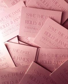 pink save the date cards are stacked on top of each other