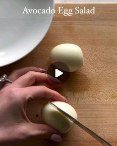 someone is peeling an egg on a cutting board