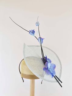 "Feel like you are in an airy dream with a floral celebration of spring using delicate ostrich quill sprays and flowers that arise from the leaf like sinamay base. This fascinator is available in a variety of colors. Pair it with any outfit that needs an extra touch of exuberant elegance. - Light Weight - Approximately 9\" X 12\" - Attaches with a headband. - Many color choices for sinamay base.  Please contact me if the color you want is not listed. - Each piece is unique and will vary slightly. If you have any special requests or questions please don't hesitate to contact me.  Color samples are available upon request. Need a different color?  Message me and I will do my best to meet your needs. This is a made to order item with production starting after order is placed.  Turnaround time Elegant Flower Headpieces For Spring, Whimsical Adjustable Fascinator For Spring, Whimsical Spring Fascinator For Races, Fitted Whimsical Spring Fascinator, Whimsical Fitted Fascinator For Spring, Spring Adjustable Fascinator With Handmade Flowers, Whimsical Evening Headpieces For Spring, Spring Garden Party Headpiece With Flower Decoration, Adjustable Flower Shaped Fascinator For Garden Party