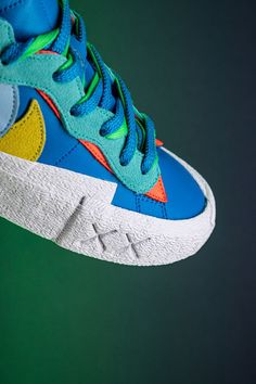 The recent run of three-way sneaker collaborations has been fueled by the contingency of high fashion brand Sacai, famed artist Kaws, and Nike. Each entity brings its signature design elements to the Blazer Low seen here. Kaws Blue, High Fashion Branding, Signature Design, Saucony Sneaker, Design Elements