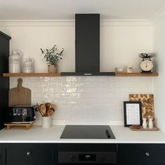 a black stove top oven sitting inside of a kitchen next to a microwave and counter