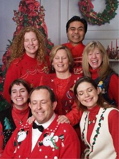 a group of people wearing ugly christmas sweaters