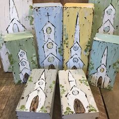 four painted wooden boxes sitting on top of a table