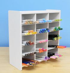 a white display case filled with lots of different colored crayons