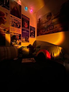 a bedroom with posters on the wall and lights in the ceiling, along with an unmade bed