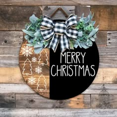 a merry christmas sign hanging on the side of a wooden wall